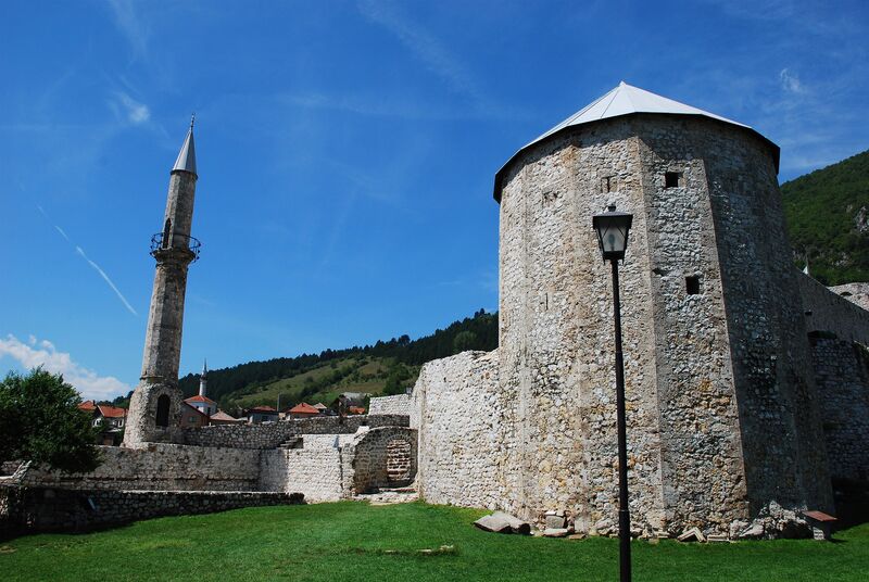 The stone walls and tower of Travnik Fortress overlook the surrounding hills.
