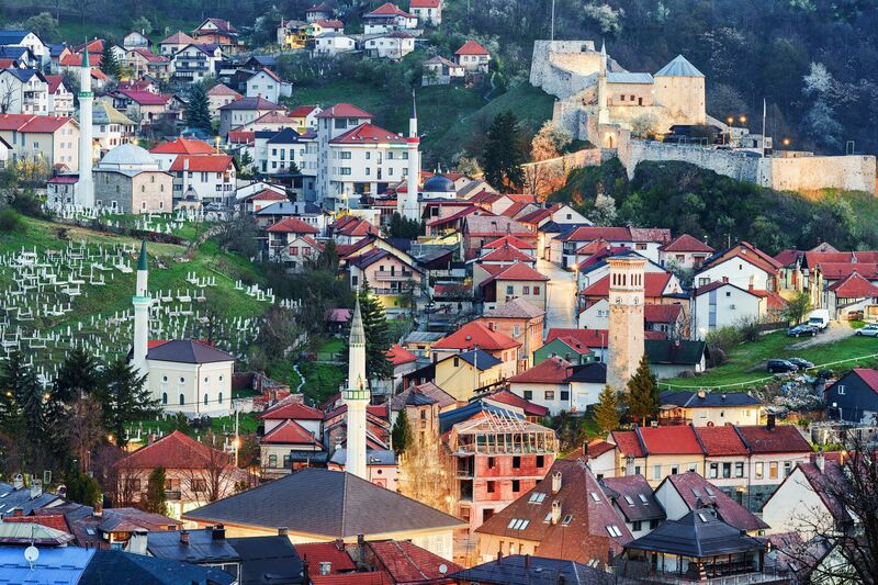 A wide view of Travnik's old town featuring the medieval fortress and Ottoman architecture.
